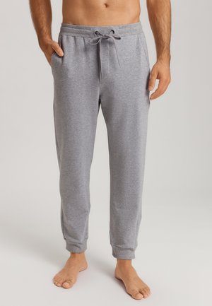 Graue Sweatpants aus einem weichen Stoff, mit einem elastischen Bund und Kordelzug, seitlichen Taschen und Bündchen an den Knöcheln.