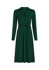 Grünes Kleid mit langen Ärmeln, Kragen und Knopfverschluss. Es hat eine gebundene Taille und kleine schwarze Punkte auf einem glatten Stoff.