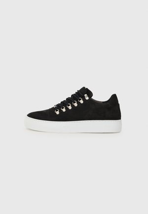 Black suede sneaker featuring a white rubber sole, round toe, and metal eyelets for laces, with a low-top design and textured upper.