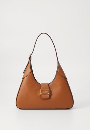 Bruine leren Kate Spade handtas met een enkele band en een gouden vierkante logoplaat aan de voorkant tegen een effen lichte achtergrond.