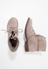 Suede ankle boots in light gray with round toes, lace-up front, and soft inner lining. Flat wooden soles with minimal tread pattern.