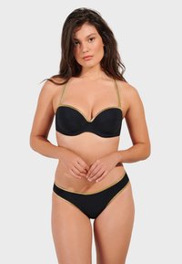 Black bikini set featuring a padded, underwire top and matching bottoms. Gold accents along the edges, smooth texture, and adjustable straps.