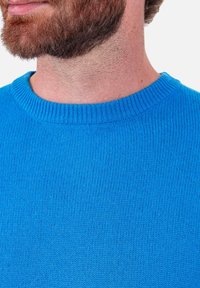 Hellblauer Strickpullover mit einem gerippten Rundhalsausschnitt. Die Textur ist glatt mit einem gleichmäßigen Muster und ohne sichtbare Verzierungen.