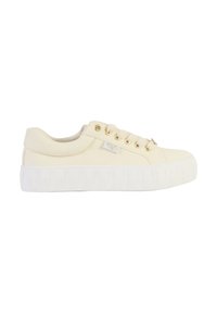 Cream canvas sneakers with a thick white rubber sole, gold eyelets, and a textured sole. Features a subtle logo on the side.