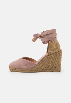 Różowe espadryle na koturnie z zaokrąglonym noskiem i plecionym podbiciem z juty. Pasek na kostkę posiada materiałowy sznurek i teksturowany tylny panel.