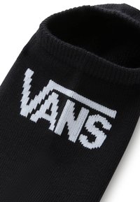 Sort strømpe med ribbet kant, med det markante hvide "VANS" logo strikket i midten. Blød tekstur, typisk atletisk stil.