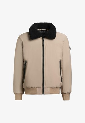 Beżowa kurtka typu bomber z czarnym kołnierzem ze sztucznego futra, zamkiem z przodu oraz bocznymi kieszeniami. Miękka w dotyku, z ściągaczami na mankietach i u dołu.