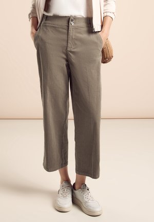 Light gray linen cropped pants with a relaxed fit, featuring front pockets and two button closure, paired with white sneakers.