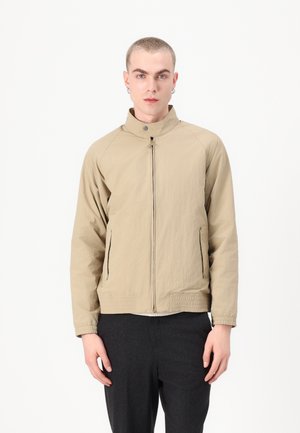 Light khaki zip-up jacket with a stand collar, two side pockets, and elastic hem. Textured fabric with a slightly crinkled appearance.