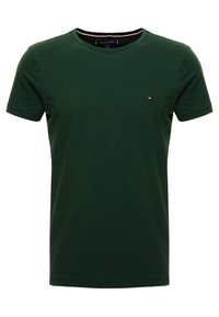 Green cotton T-shirt with short sleeves, crew neck, featuring a small logo on the chest. Smooth texture, classic fit.