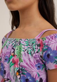 Colorful floral off-the-shoulder top featuring a purple background, elastic neckline, and thin straps with accent colors in a tropical design.