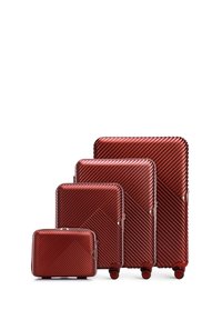 Four hard-shell suitcases in a deep red color, featuring a diagonal ribbed pattern, smooth texture, and four wheels for easy mobility.