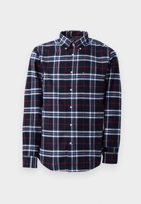Camicia a quadri nei colori blu navy, rosso e bianco. Design button-up con colletto e maniche lunghe. Materiale in cotone con dettaglio della tasca.