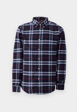 Camicia a quadri nei colori blu navy, rosso e bianco. Design button-up con colletto e maniche lunghe. Materiale in cotone con dettaglio della tasca.