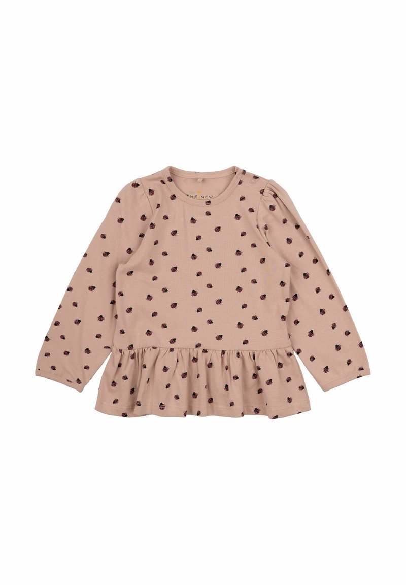Rosa Langarmoberteil mit gerafftem Peplum-Saum, das kleine dunkle Punkte aufweist, aus weichem Baumwollstoff gefertigt. Mit rundem Ausschnitt.