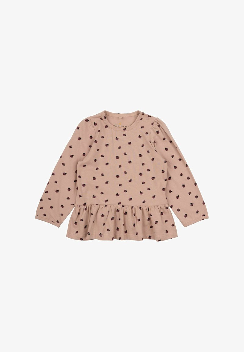Pink long-sleeve top with a gathered peplum hem, featuring small dark dots throughout, made of soft cotton fabric. Includes round neckline.