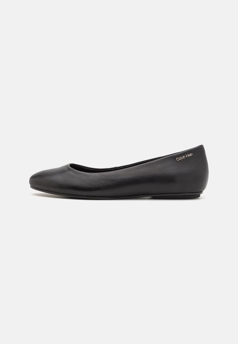 Black leather ballet flat with a rounded toe, minimalistic design, and a subtle logo on the heel. Smooth texture and low-profile shape.