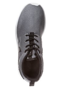 Black and white mesh athletic shoe with a rounded toe and black laces. Features a cushioned sole and textured fabric.