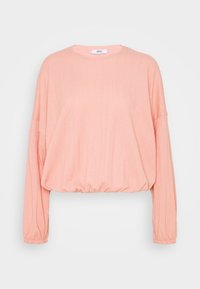 Vaaleanpunainen cropped-neule, jossa on pitkät hihat, teksturoitu kangas, pyöreä kaulus ja joustava helma. Rentouttava muotoilu, joka sopii kerrokselliseen pukeutumiseen.