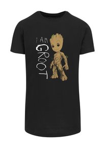 Juodas marškinėliai su Grooto grafika ir tekstu "AŠ ESU GROOT" balta spalva. Dizainas apima rudus ir žalius akcentus ant Grooto.