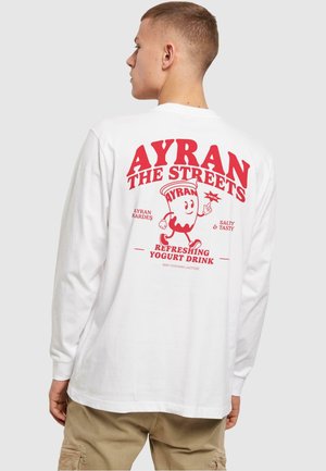 White long-sleeve t-shirt featuring a red graphic on the back with "AYRAN THE STREETS" and an illustration of a yogurt drink.