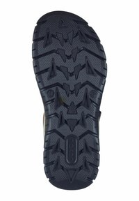 Black rubber shoe sole featuring a textured surface with prominent angular tread patterns for enhanced grip. Includes brand logo.