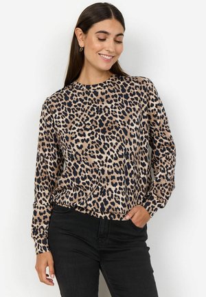 Lepardprint lange mouwen top in bruin en zwart. Zachte stof met een ontspannen pasvorm, ronde halslijn en elastische manchetten. Gecombineerd met donkere jeans.