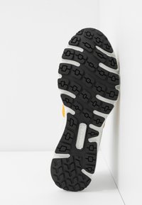 Svart gummiyttersula med texturerat mönster, vit mellansula och gul accent. Produkten är märkt "ecco" med storlek 37 tydligt synlig.