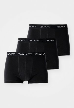 Kolm paari musti bokserpükse, mille elastsel vööl on valge GANT-i logo. Omadused: sile kude ja istuv, reie keskele ulatuv lõige.