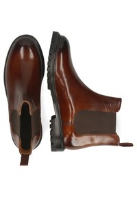Bottines en cuir marron avec une finition lisse, panneaux latéraux élastiques, tirette et semelles en caoutchouc texturé. Design épuré avec des orteils arrondis.
