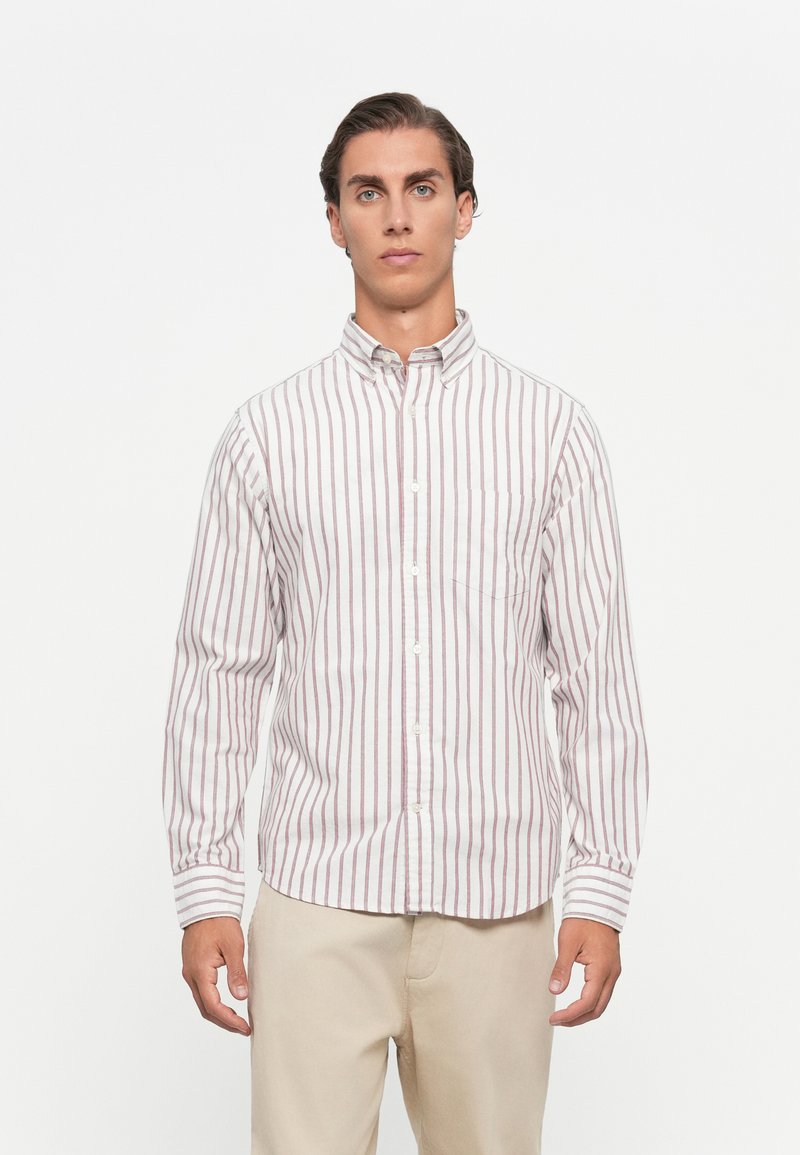 Chemise à rayures blanches avec des rayures verticales rouges, dotée d'un col et d'une poche poitrine unique. Fabriquée en tissu en coton léger.