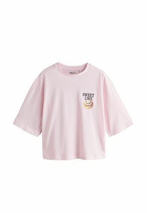 Rozā īsroku kokvilnas T-krekls. Kreisajā krūtīs rakstīts "SWEET LIKE" ar spirālveida dizainu. Brīvs piegriezums.