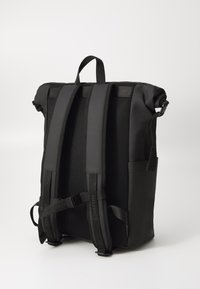 Black backpack with padded, mesh back panel and adjustable straps. Features a top handle and side pockets for storage. Smooth, durable material.