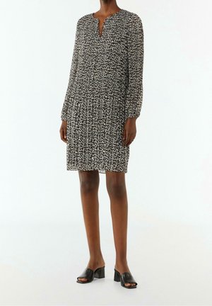 Leopardenmuster Kleid aus leichtem Stoff, mit V-Ausschnitt, langen Ärmeln und lockerer Passform. Kombiniert mit schwarzen Blockabsatz-Mules.