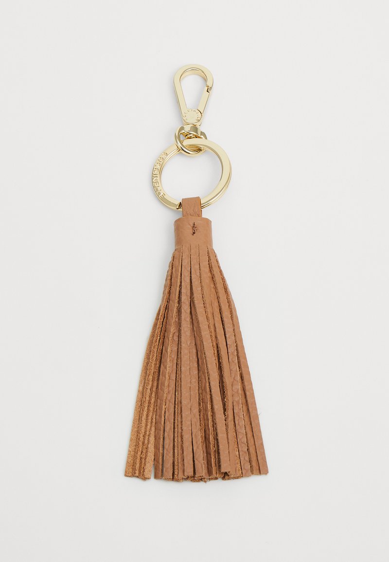 Porte-clés en cuir marron avec un clip et un anneau en métal doré. La frange présente plusieurs mèches pour ajouter de la texture et du détail.