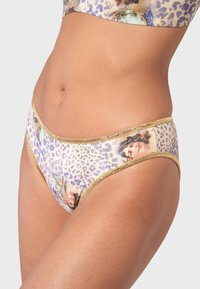 Leopard print bikini bottom with gold trim. Features illustrations of faces and a smooth texture. Fitted design enhances shape.