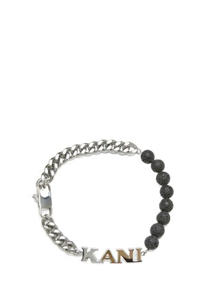 Silver chain bracelet featuring black lava stone beads, with the name "KANI" in a polished silver finish. Lobster clasp closure.