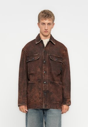 Brown, textured denim jacket featuring four front pockets, button closures, and contrasting stitching. Relaxed fit with a collar.