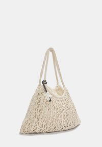 Borsa lavorata a maglia beige a forma triangolare, con un morbido rivestimento interno, doppi manici e un accento floreale attaccato a un manico scuro.