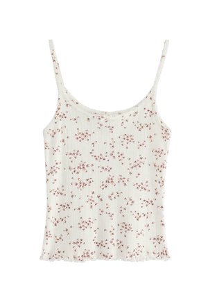 Vit blommig mönster cami med tunna axelband, med en texturerad ribbad design och en volangkant. Blommorna är i rosa och beige toner.