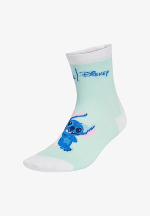 Calcetines de un suave verde menta con acentos blancos, que presentan un personaje de dibujos animados azul con orejas y ojos grandes, y el logo de Disney impreso arriba.