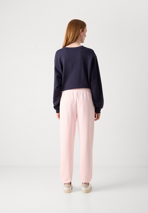 TONAL SHIELD - Tracksuit bottoms - salmon2