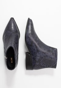Stivaletti alla caviglia a punta in finta pelle di serpente blu scuro con tacco basso a blocco; chiusura con cerniera laterale e motivo superficiale testurizzato.