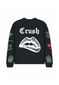 Felpa nera con una grafica di labbra bianche e testo "Crush". Presenta toppe colorate sulle maniche e vari accenti grafici. Tessuto morbido.