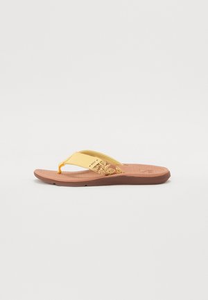 Žute japanke s ukrasnim cvjetnim uzorkom na trakici, mekanim teksturiranim uloškom i smešnim gumenim đonom. Podesivi čarape.