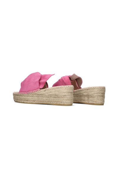 Roze suède espadrilleslides met een geweven juten platformzool, voorzien van een grote, vloeiende strik aan de voorkant voor een textuurdetail.
