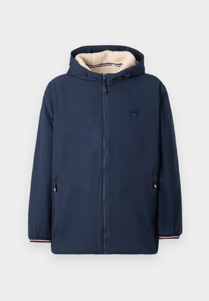 Navy blue hooded jacket with a zip front, fleece lining, two zippered side pockets, and elastic cuffs with a striped accent.