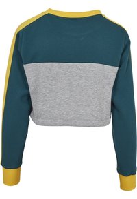 Sudadera recortada con parte superior en color teal y sección inferior gris, con acentos amarillos en las mangas y el cuello; fabricada con tela texturizada.