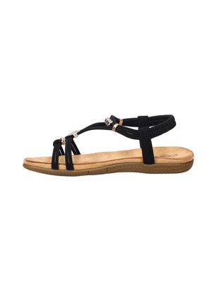 Black strappy flat sandal with elastic back strap, cushioned tan footbed, rubber sole, and decorative silver beads on the straps.