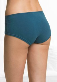 Mutandine hipster in cotone teal con una texture liscia, vita elastica e cuciture decorative sui lati.